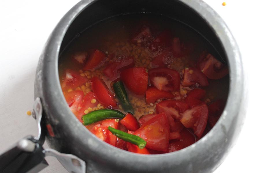 Cooking dal and tomatoes in a pressure cooker