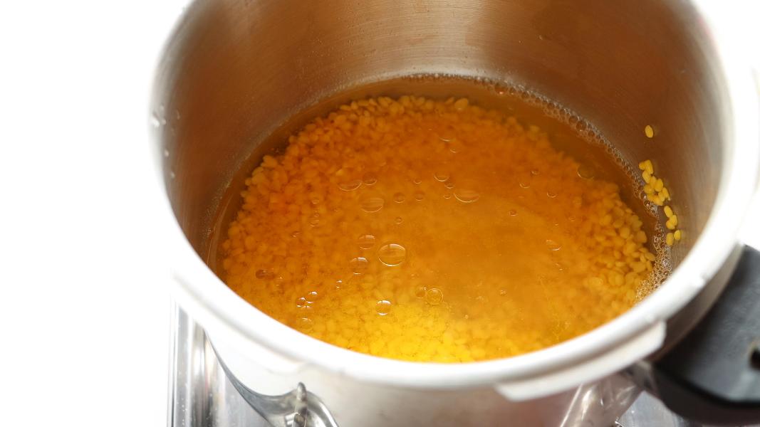 water and turmeric added to the rinsed moong dal