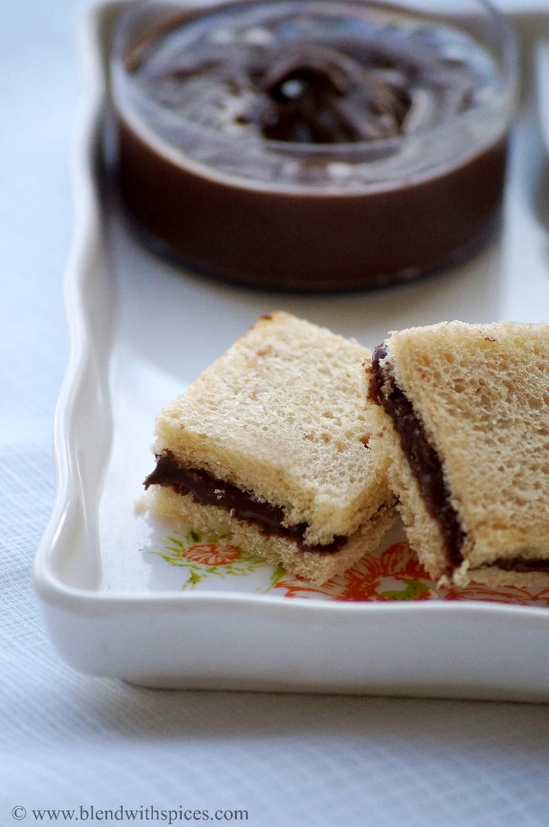 white bread sliced sandwiched with homemade chocolate peanut butter and served on a white tray