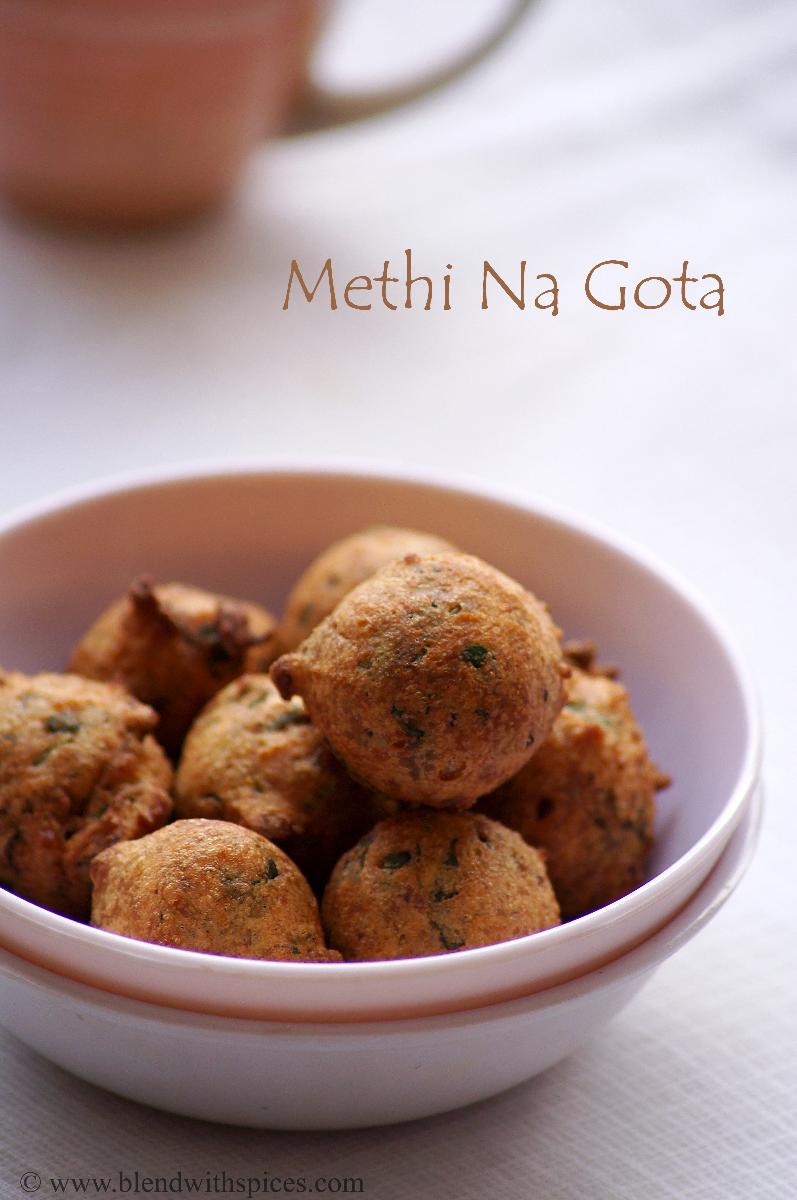 a bowl of hot methi pakoras with a cup of coffee