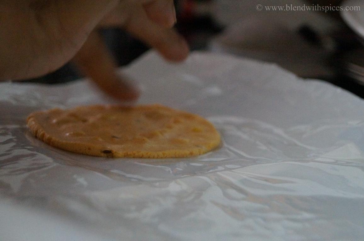 flattening the chekkalu dough into a round disc