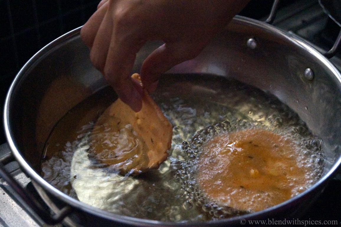 frying the chekkalu in hot oil