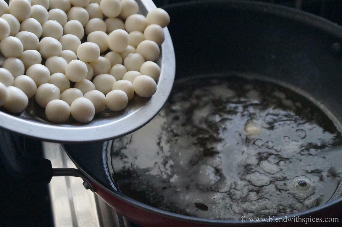 Adding rice flour dumplings to simmering jaggery syrup for making paal kolukattai.