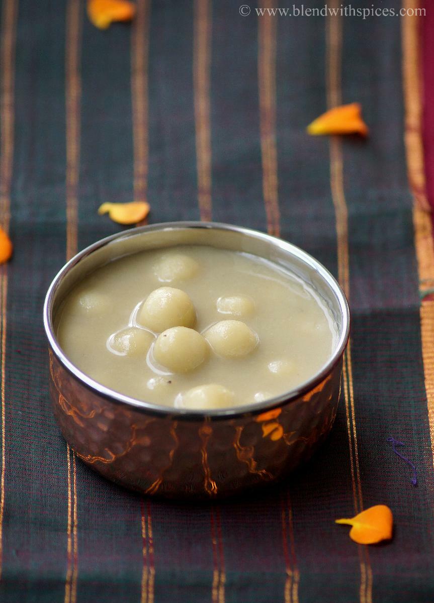 Paal kolukattai, soft rice flour dumplings cooked in sweet coconut milk, served in a traditional bowl.