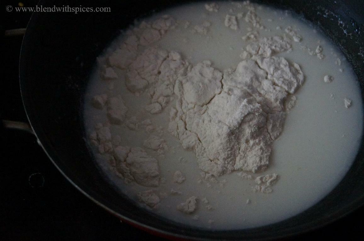 Mixing rice flour with milk to prepare the dough for paal kozhukattai.