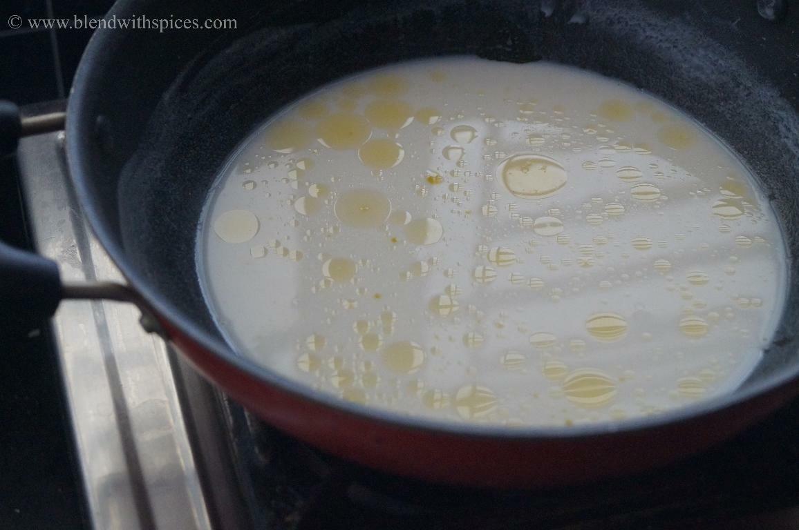Stirring rice flour, coconut milk, and ghee until a soft dough forms for paal kozhukattai.