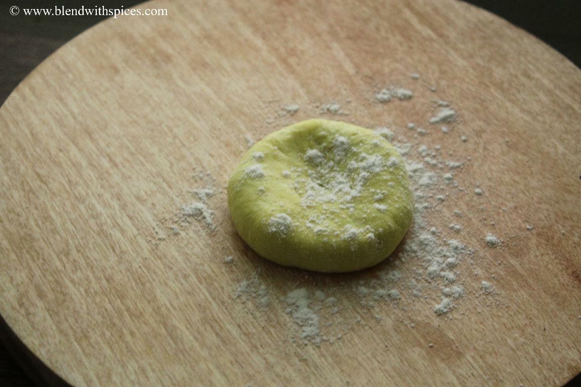 Stuffed coconut poli dough gently flattened before rolling