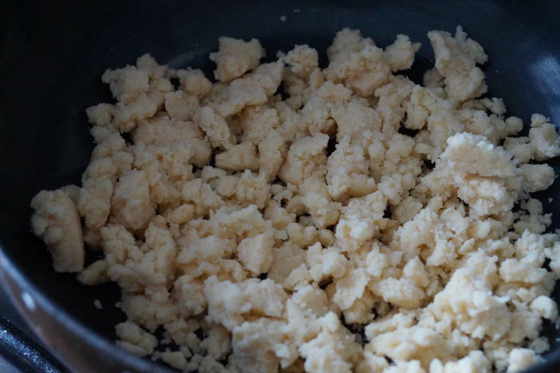 Crumbled khoya cooked in a pan for making kesar burfi.
