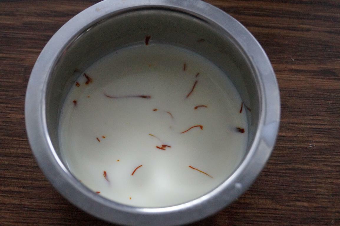 Saffron soaked in warm milk for making tutti frutti kesar burfi.