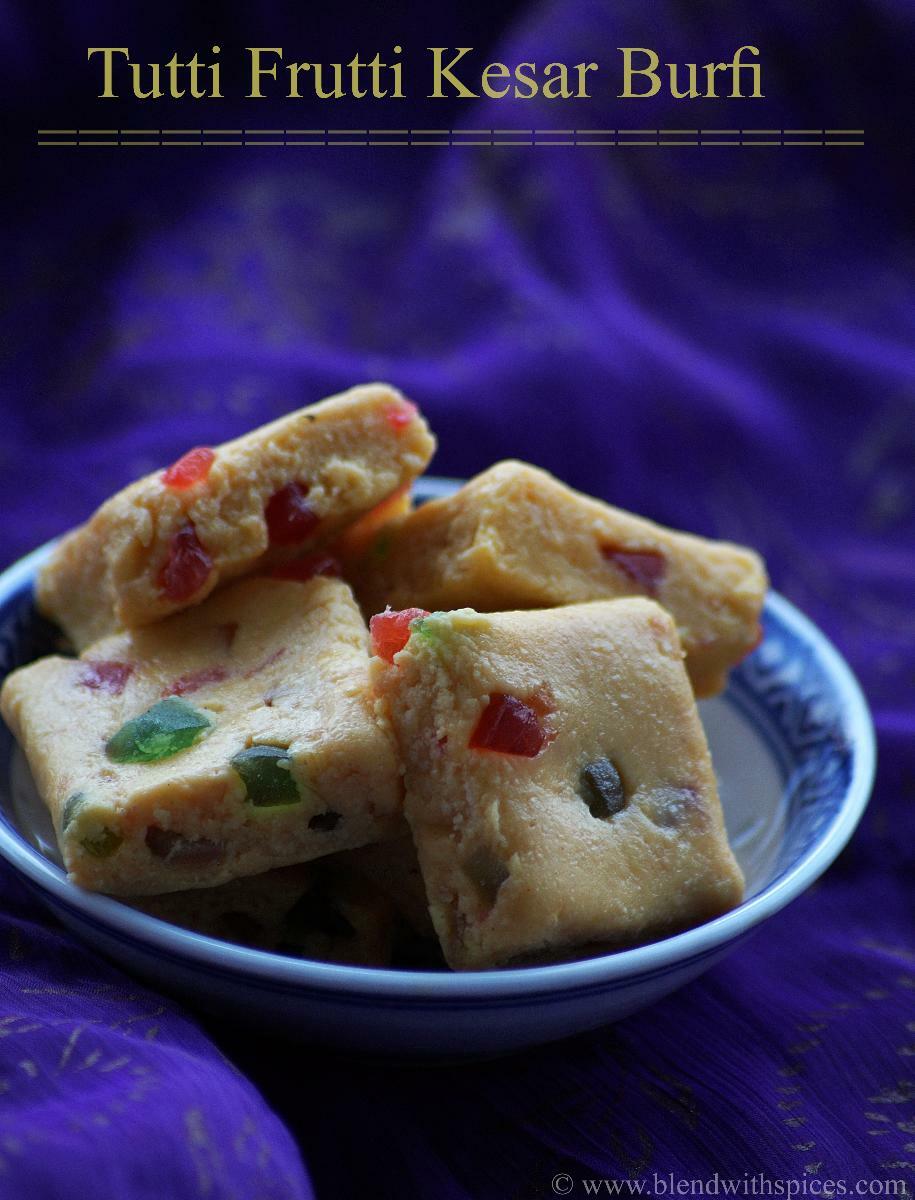 Homemade Indian kesar burfi made with khoya, sugar, saffron, cardamom powder and colorful tutti frutti. Served in a small bowl.