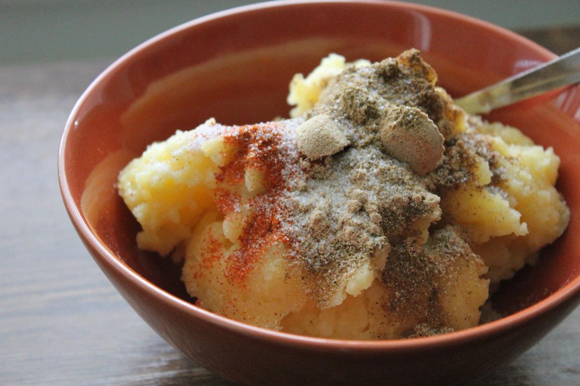 mashed boiled potatoes and Indian spices are mixing together to make a spicy potato filling