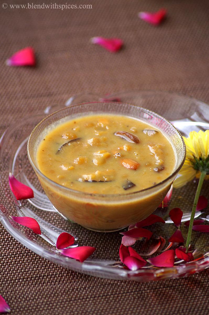 a bowl of senaga pappu payasam or chana dal kheer, garnished with nuts and flowers
