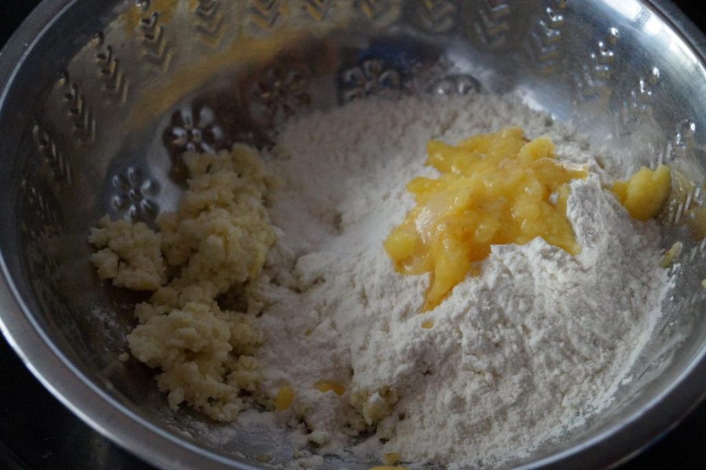khoya, flour and ghee added in a mixing bowl to make makkan peda