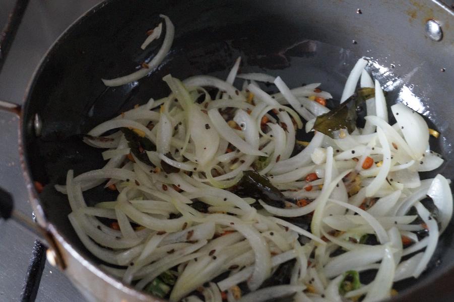 frying onions to make the healthy quinoa upma