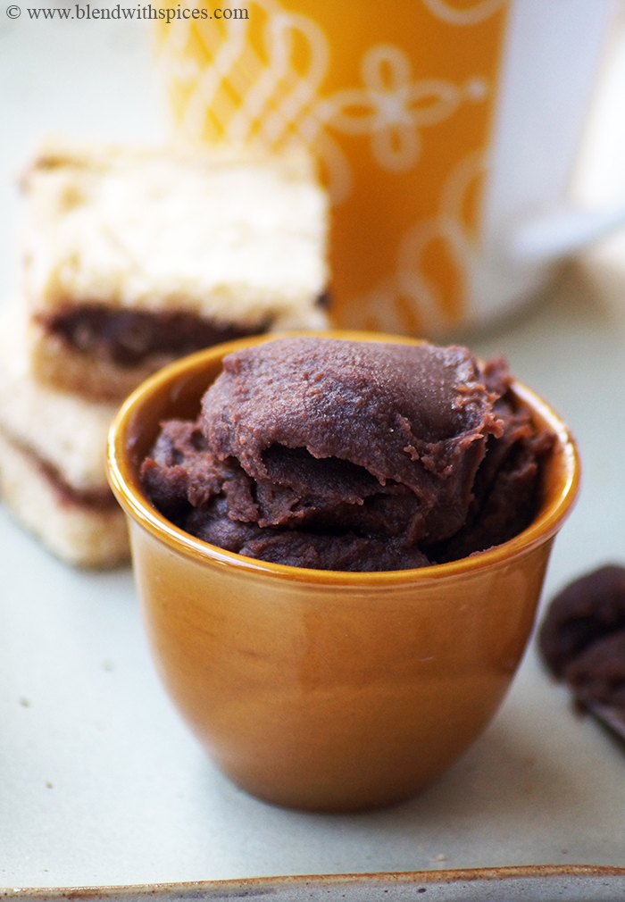 a close up view of chestnut chocolate spread along with bread and yellow mug