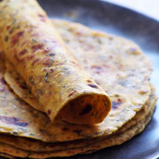 soft rolled Indian dry fenugreek flatbreads places on a black plate