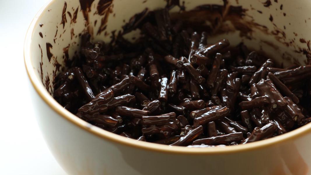 Pretzels are coated with melted chocolate to make pretzel nests
