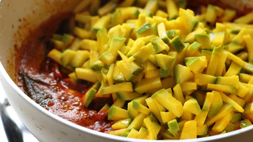 Marinated mango pieces added to the red chili spice mixture 