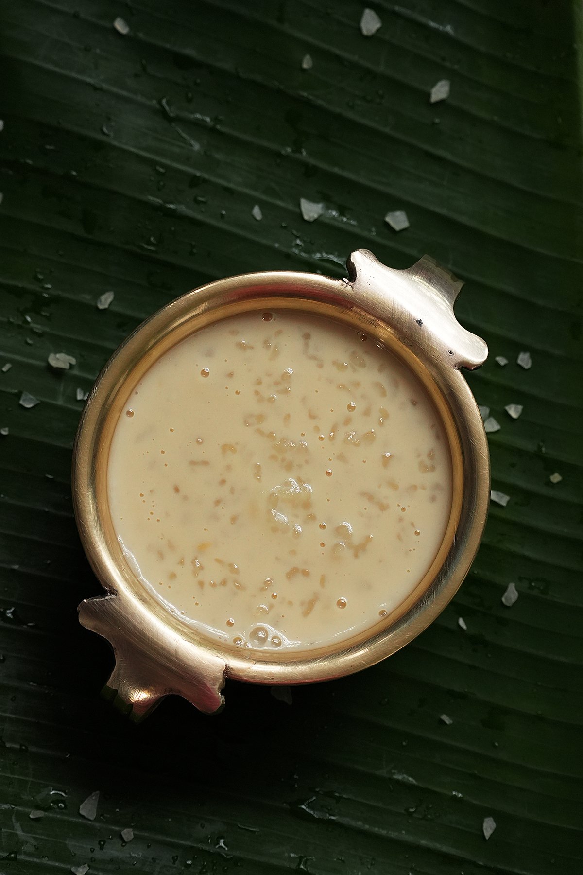 Classic kerala ada payasam served in a small uruli (brass vessel), placed on a banana leaf