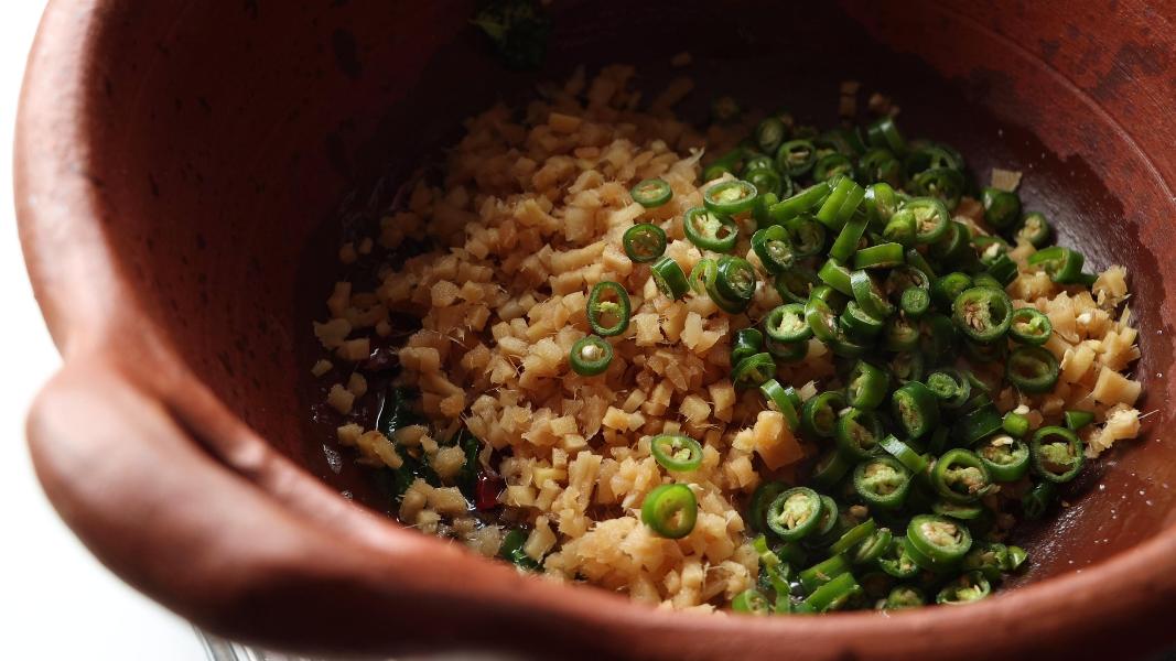 finely chopped ginger and finely chopped green chilies added to a clay pot