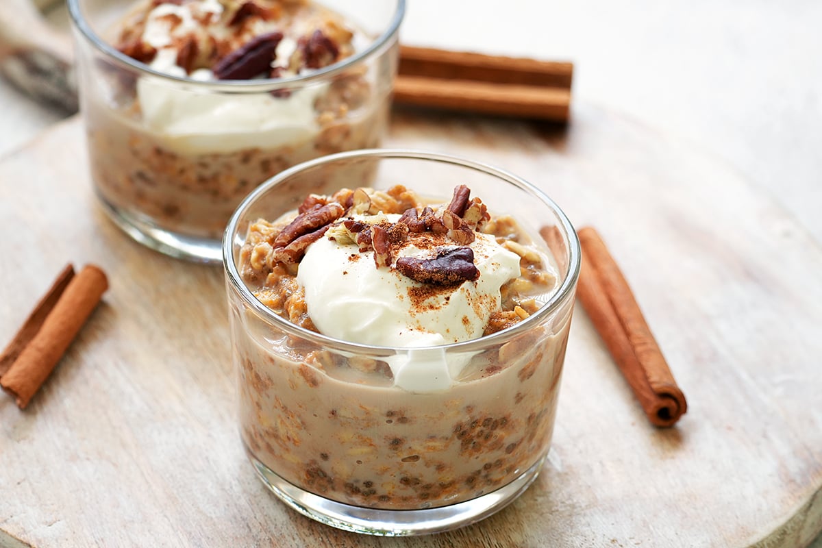 Pumpkin pie overnight oats topped with yogurt and pecan nuts.