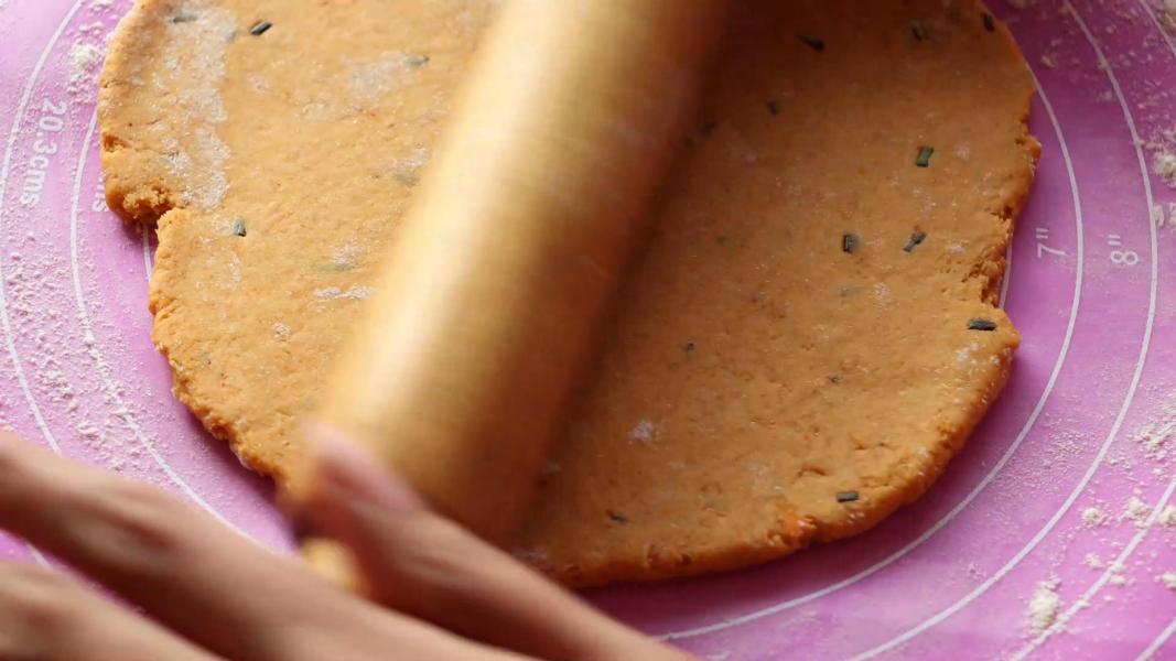 Rolling dough using a rolling pin.
