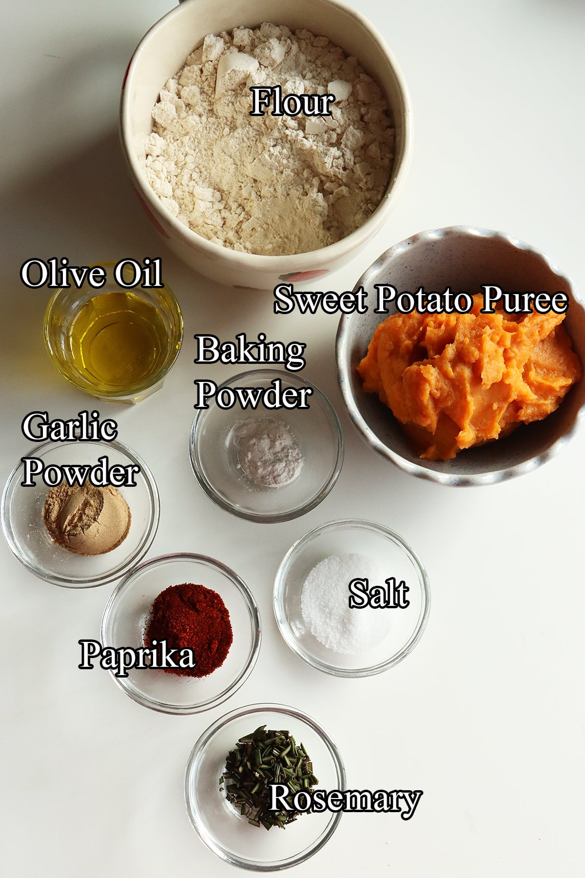Top-down view of the ingredients for sweet potato crackers arranged on a white surface.