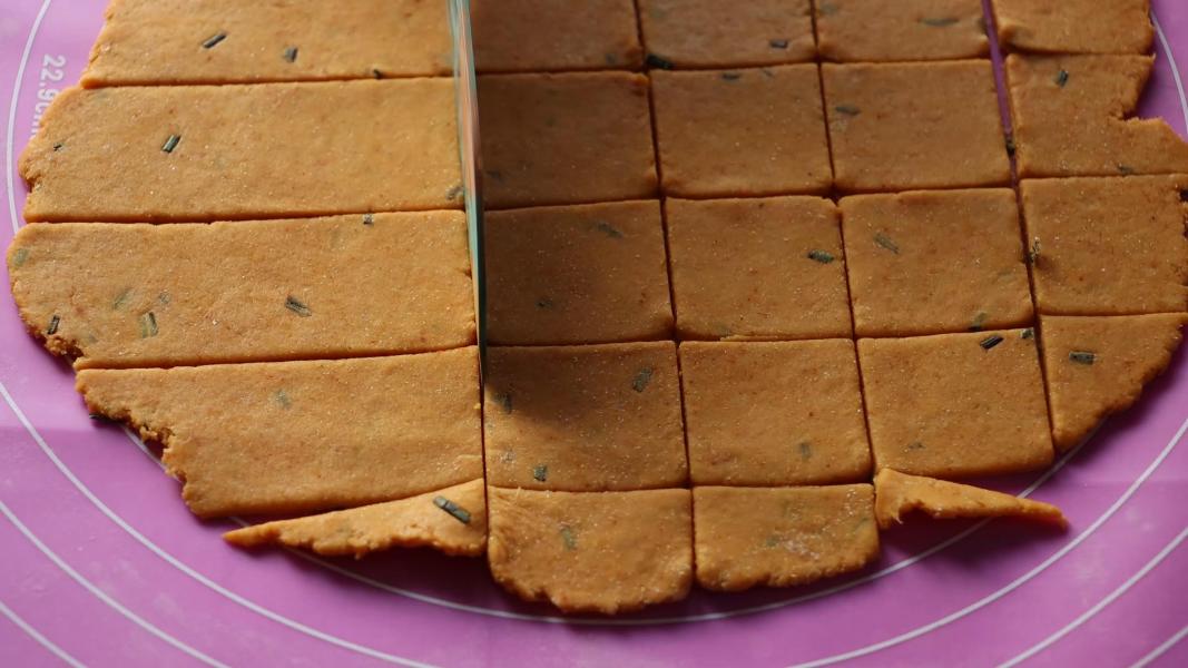 Cutting the rolled dough into small pieces.
