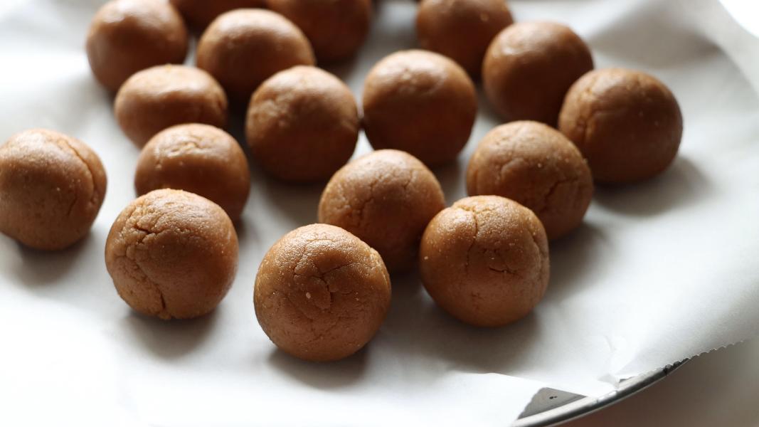 Shaped truffles arranged on a lined tray to chill in the fridge