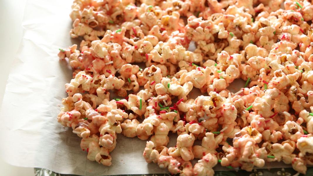 candy cane covered popcorn on a lined tray